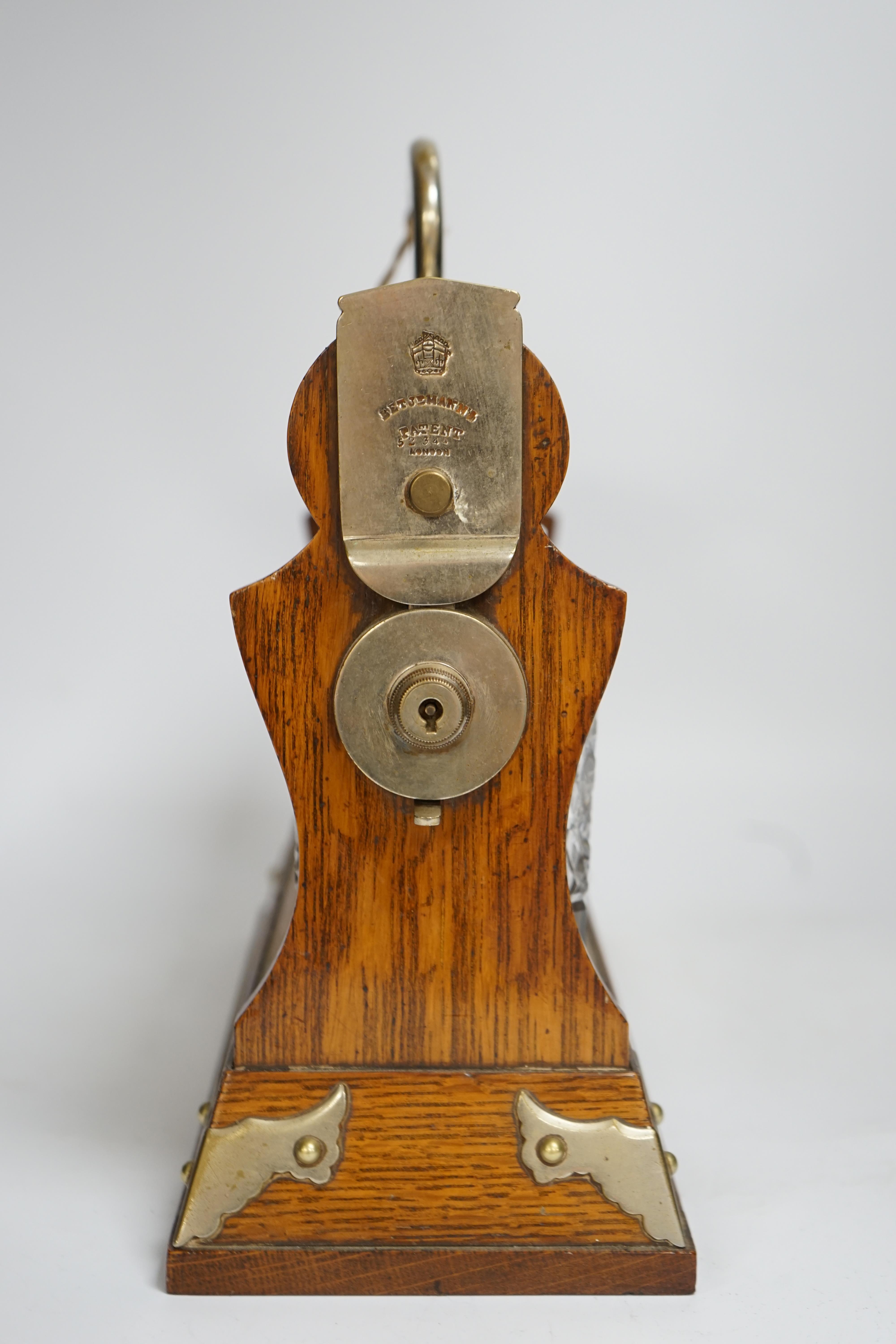 A Betjemann’s patent oak three bottle tantalus with key, 32cm wide